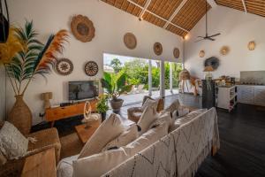 a living room with a couch and a tv at Villa Moana Poe Uluwatu in Uluwatu