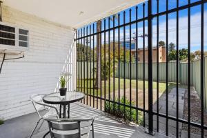 a patio with a table and chairs on a balcony at Apartment 2 Burswood in Perth