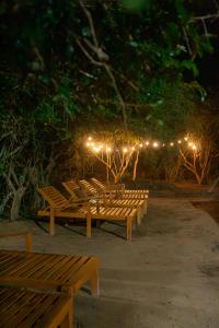 a row of wooden benches with lights on them at Lowin Yala in Yala
