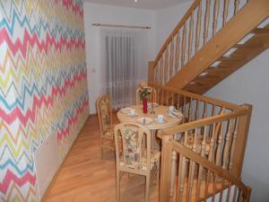 a dining room with a table and a colorful wall at Ferienwohnung an der Therme in Bad Schandau
