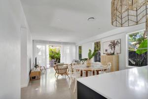 a kitchen and dining room with a table and chairs at BEIJO DO MAR - your ultimate luxury beach house retreat in Callala Beach