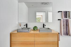 two sinks on top of a wooden counter in a bathroom at BEIJO DO MAR - your ultimate luxury beach house retreat in Callala Beach +49 photos