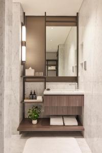 a bathroom with a sink and a mirror at Amara Singapore - Newly Renovated in Singapore