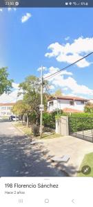 a picture of a street with a sign on a pole at EZEIZA BED and BREAKFAST A 3KM AEROPUERTO EZEIZA in Ezeiza