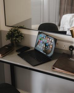 a laptop computer sitting on top of a desk at Magazine Vista Hotel Managed by The Ascott Limited in George Town