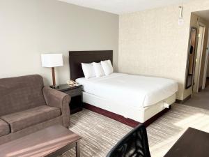 um quarto de hotel com uma cama e um sofá em Kiteville Cedar Rapids em Cedar Rapids