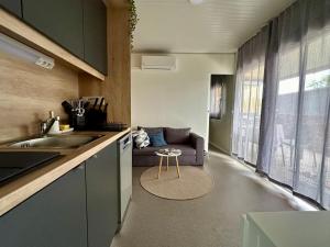 a kitchen with a couch and a living room at BREZA mobile house BIG BERRY in Metlika +41 photos