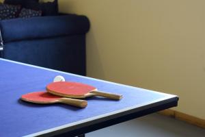 two tennis rackets sitting on top of a table at Bicheno Bliss in Bicheno