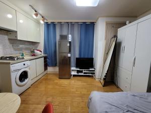 a kitchen with a washer and dryer in a room at Changdong Property in Seoul