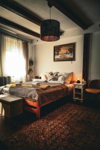 a bedroom with a large bed and a window at Kisház Apartman in Eger