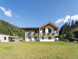 a house on a hill with a grass field at Chalet in Saalbach near Ski Lift in Saalbach-Hinterglemm +32 photos