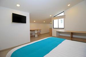 APART HOTEL CASA BLANCA tesisinde bir odada yatak veya yataklar