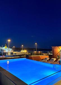 a swimming pool on top of a building at night at Nidus Villa in Souda