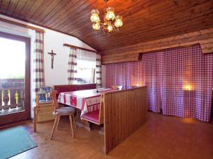 a kitchen with a table and a cross on the wall at Chalet in Sankt Johann near Ski Lift in Wagrain