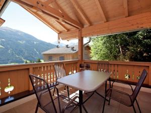 a wooden deck with a table and chairs on it at Chalet in Mittersill near Ski Slopes in Mittersill