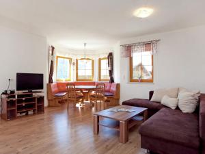 a living room with a couch and a table at Chalet in Mittersill near Ski Slopes in Mittersill +32 photos
