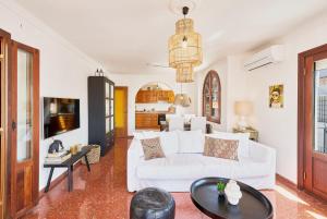 a living room with a white couch and a table at Balcon de Europa in Nerja by Solaga Holiday Homes in Nerja