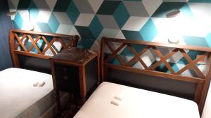 two bunk beds in a room with a geometric wall at un îlot de calme in Morlaix