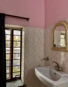 baño con lavabo blanco y ventana en JWALA JAIPUR, en Jaipur