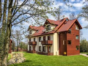 una casa con un tetto rosso su un cortile verde di Karpacz Comfortable holiday residence a Karpacz