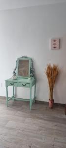 a green table with a mirror in a room at Mojácar Vibes 1 Línea de Playa in Mojácar