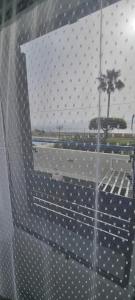 a view from a window of a building with a palm tree at Mojácar Vibes 1 Línea de Playa in Mojácar