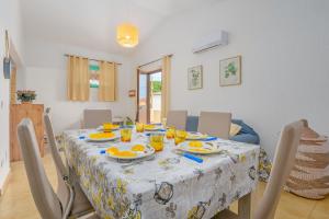 a dining room table with a table cloth on it at Casa Vacanze Cannigione in Cannigione +15 photos