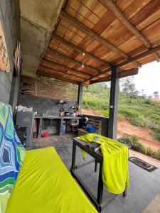 a room with a bed and a table with a kitchen at Backpackers Hostel in Ella
