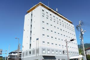 a white building with a roof on top of it at Uwajima Oriental Hotel in Uwajima
