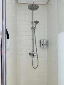 a shower with a shower head in a bathroom at El Escondite de la Muralla in Cáceres