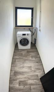 a washing machine in a small room with a window at HandwerkerHaus in Ochsenfurt +3 photos