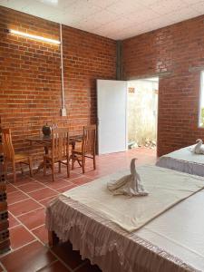 a room with a bed and a table and chairs at Chau Doc Homestay in Chau Doc