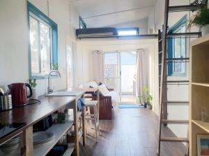a kitchen with a sink and a counter top at Blue Orchid Tiny House in Clare