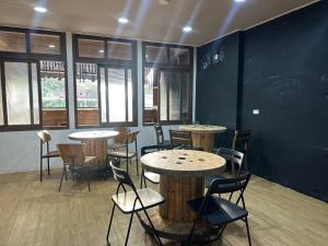 a restaurant with tables and chairs in a room at One House in Gongliao