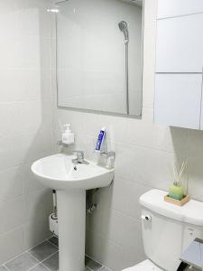 a bathroom with a sink and a toilet and a mirror at Goose Stay in Bucheon