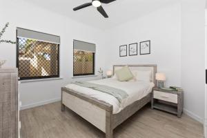 a bedroom with a bed and a ceiling fan at Beachfront Escape Private Pool and Beach Access in Mandurah +35 photos