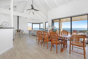 a kitchen and dining room with a table and chairs at Beachfront Escape Private Pool and Beach Access in Mandurah