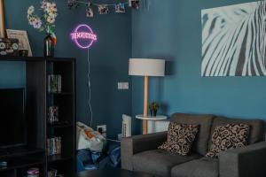 a living room with a couch and a neon sign at Garden Lane Backpackers in Dublin
