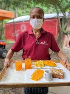 a man wearing a mask holding a tray of food at Kama Siri Koh Kood in Ko Kood