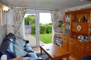 a living room with a couch and a table at Dawn in Hemsby