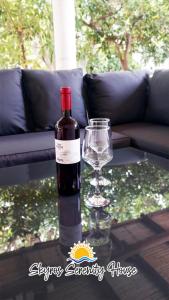 a bottle of wine and a glass on a table at Skyros Serenity House in Skiros