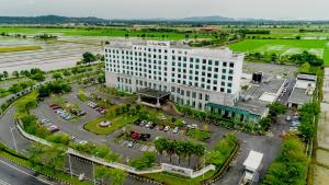 an aerial view of a large white building with a parking lot at Raia Hotel & Convention Centre Alor Setar in Alor Setar