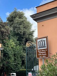 a sign on the side of a building next to a gate at Casa di Giò in Naples