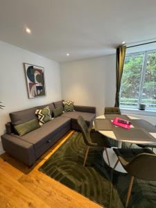 a living room with a couch and a table at Victorias House Suite in Lille