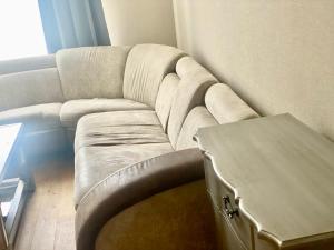 a living room with a couch and a table at Mariella Apartment Tartu in Tartu