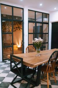 a wooden table with chairs and a vase of flowers on it at PROMO! 2BRV With premium Pool in Uluwatu