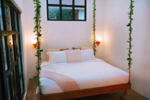 a bed in a room with a swing at PROMO! 2BRV With premium Pool in Uluwatu +20 photos