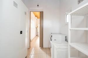 a white laundry room with a washer and dryer at Flegra House in Nea Potidaea +17 photos