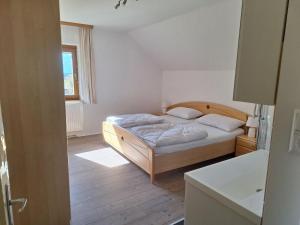 um quarto com uma cama e uma janela em Apartment in ski area in Kötschach-Mauthen em Laas
