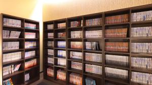 a library filled with lots of books on shelves at Dormy Inn Premium Nagoya Sakae in Nagoya